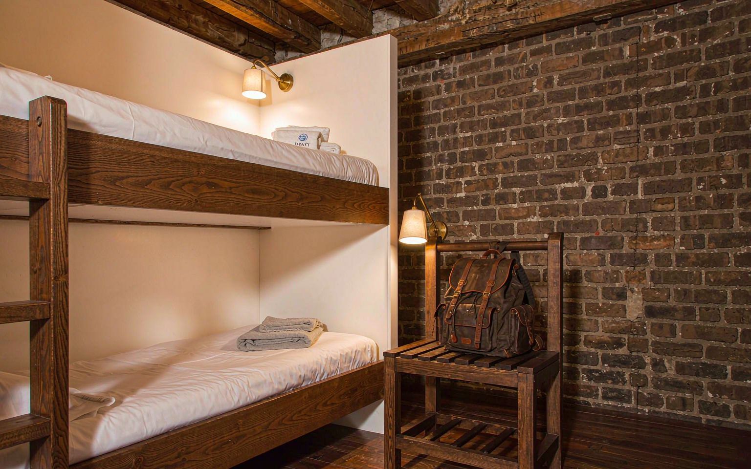 Dormitory bunks with reading lights and green blankets